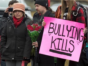 Leah Parsons, left, mother of Rehtaeh Parsons, and her partner Jason Barnes, attend a protest near the Halifax Regional Police headquarters in Halifax on Sunday, April 14, 2013. The girl's family says she ended her own life following months of bullying after she was allegedly sexually assaulted by four boys and a photo of the incident was distributed.