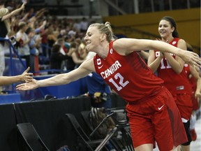 Canada's Lizanne Murphy leads the team while greeting spectators after beating the United States 81-73 in the women's basketball gold medal game at the Pan Am Games, on July 20, 2015, in Toronto.