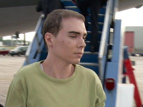 Luka Rocco Magnotta is taken by police from a Canadian military plane  on Monday, June 18, 2012. Magnotta was convicted with the first-degree-murder of Lin Jun.