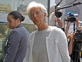 Managing director of the International Monetary Fund Christine Lagarde, centre, arrives for a meeting of eurozone finance ministers at the EU Lex building in Brussels on Saturday, July 11, 2015. Greece's negotiators head to Brussels on Saturday armed with their reform proposals and parliamentary backing to seek a third bailout, but with the shadow of severe dissent from governing lawmakers hanging over them.