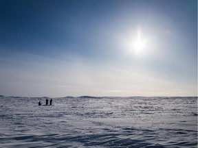 March 4, 2015. We are three hours away from the village. Our guides are digging holes through the thick ice of Virgin Lake in the hopes of catching some frozen arctic char.