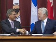 Matthew Coon Come, grand chief of the Grand Council of the Crees, left, shakes hands with Quebec Premier Philippe Couillard after they signed an agreement, Monday, July 13, 2015 at the legislature in Quebec City.