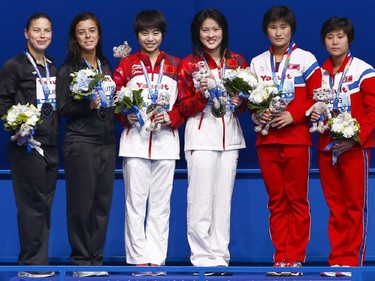 Silver medallists Meaghan Benfeito and Roseline Filion from Canada, left, gold medallists Chen Ruolin and Liu Huixia from China, centre, and bronze medalists Hyang Un Kim and Nam Hyang Song from North Korea, right, pose after the medal ceremony for the women's synchronised 10m platform diving final at the Swimming World Championships in Kazan, Russia, Monday, July 27, 2015.