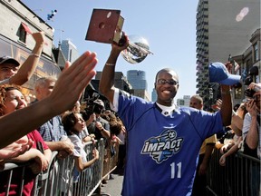 Impact player Lloyd Barker carries the A-League trophy down Crescent St. in Montreal  on Sept. 23, 2004. Barker will be coaching a celebrity team at the annual GOALMTL — Lions Cup charity soccer tournament.