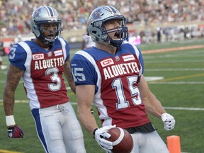 Montreal Alouettes wide receiver Samuel Giguère (15) celebrates his touchdown against the Calgary Stampeders with teammate Cody Hoffman (3) during first half CFL football action in Montreal, Friday July 3, 2015.