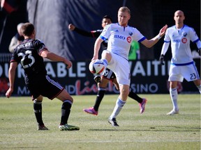 WASHINGTON, DC - MARCH 07: Perry Kitchen #23 of D.C. United defends as Calum Mallace #16 of Montreal Impact kicks the ball during the first half at RFK Stadium on March 7, 2015 in Washington, DC.