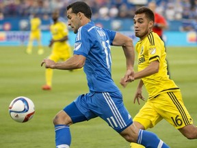 Montreal Impact's Dilly Duka, left, outruns Columbus Crew's Hector Jimenez taking the ball forward during first half MLS soccer action in Montreal on Saturday, July 11, 2015