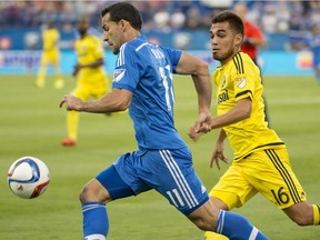 Montreal Impact's Dilly Duka, left, outruns Columbus Crew's Hector Jimenez taking the ball forward during first half MLS soccer action in Montreal on Saturday, July 11, 2015