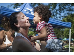 Lisanne Dion plays with Jayden, 2, during a block party on John White Street in Kirkland in  2013.