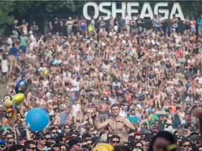 Music fans enjoy the performance by Scottish electronic band CHVRCHES at the 2014 Osheaga Music Festival at Jean-Drapeau Park in Montreal on Sunday, August 3, 2014.