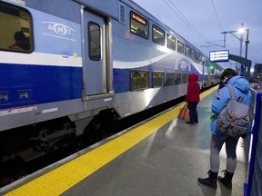 Passengers get ready to board a morning from Mascouche at the Ahuntsic station in Montreal, Monday December 1, 2014.