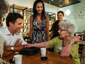 Liberal Leader Justin Trudeau talks with Cecilia Simard of Montreal, as Hochelaga candidate Marwah Rizqy, centre, looks on at the Marché Maisonneuve on Ontario St. East, in Montreal on Friday, July 31, 2015.