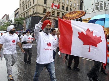 Members of Montreal's Sikh community march in the Canada Day parade on Ste-Catherine St. in Montreal Wednesday July 1, 2015.