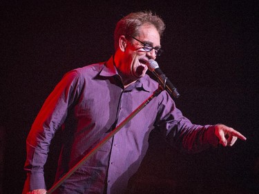 Huey Lewis gestures to the audience during the opening number as he performs in concert at Salle Wilfrid-Pelletier of Place des Arts during the Montreal International Jazz Festival in Montreal, on Wednesday, July 1, 2015.