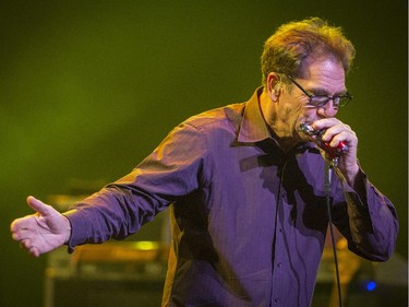 Huey Lewis plays the harmonica  during the opening number as he performs in concert at Salle Wilfrid-Pelletier of Place des Arts during the Montreal International Jazz Festival in Montreal, on Wednesday, July 1, 2015.