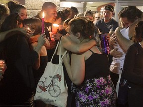 People gather for a candlelight vigil in Lasalle July 10, 2015, in memory of Samantha Higgins.