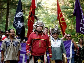 Kanesatake Mohawks march through the Pines to mark the 25th anniversary of the Oka Crisis in Kanesatake, north of  Montreal ,on Saturday, July 11, 2015.