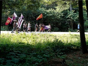 Kanesatake Mohawks walk along highway 344 in Oka north of Montreal on Saturday July 11, 2015. The Mohawks held a march to mark the 25th anniversary of the 1990 Oka Crisis.