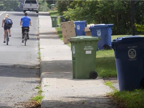 Bins for recyclable and compostable waste line St-Jean Boulevard in Pointe-Claire on Tuesday, July 14, 2015.  Though recycling and compost are picked up weekly, the city has reduced pickup for other garbage to every two weeks.