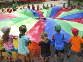 Campers bounce balls in a parachute at St-Lazare's day camp at the  Centre de Plein Air Les Forrestiers de St-Lazare on Tuesday, July 14, 2015.