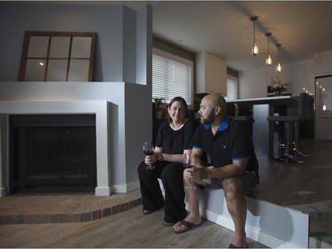 Erin Lefler and  Octavio Mateus look at their unfinished living room.