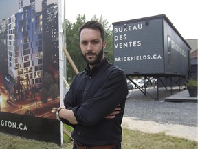 Hugo Girard-Beauchamp in front of new condo development project, Brickfields, on the corner of Wellington and de la Montagne in Griffintown on Tuesday July 14, 2015. (Pierre Obendrauf / MONTREAL GAZETTE)