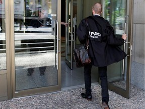 An investigator with Quebec's permanent anti-corruption squad (UPAC) in action.