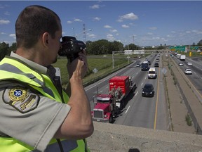 Sûreté du Québec officer Brunot Girard during radar operation on Highway 20 near the Lafontaine tunnel on Thursday July 16, 2015. Many Quebequers go on summer holidays Friday.
