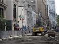 Construction crews work on Peel Street between Ste-Catherine and De Maisonneuve in Montreal, Friday July 17, 2015.