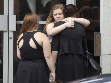 Friends and family of the murdered Samantha Higgins console each other outside the Feron's Funeral Home in Montreal, Saturday July 18, 2015.