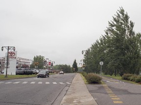 St-Joseph Blvd. in Lachine near Sixth Ave., looking east, showing the canal on the right and the Spinelli auto dealership on the left.  The borough has long-term plans to convert this area north of the canal into a residential sector.