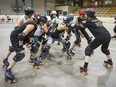 Skaters form up as they prepare to start a race during Roller Derby practice at the Arena St-Louis in Montreal, on Thursday, July 23, 2015.
