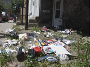 Garbage is strewn on the lawn of a home on St-Dominique St.