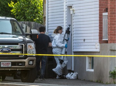 Police investigate after three bodies were found inside a home on de Blois Street in Boucherville, July 3, 2015.