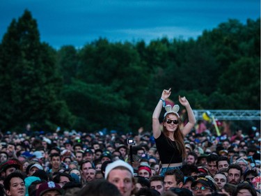 A music fan enjoys the performance by Of Monsters and Men on day one of the 2015 edition of the Osheaga Music Festival at Jean-Drapeau Park in Montreal on Friday, July 31, 2015.