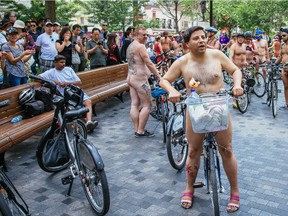 People take part in the Montreal World Naked Bike Ride at Dorchester Square in downtown Montreal on Sunday, July 5, 2015.