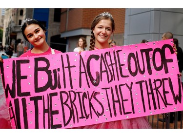 Taylor Swift fans Eve Bureau, left, and Sarah Guerra of Mexico wait outside the Bell Centre in Montreal on Tuesday July 7, 2015.