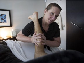 Kim Holdbrook works on massage therapist Daniel Morris before his shift at her Hands That See clinic in the Côte-Saint-Luc area of Montreal Wednesday, July 8, 2015. Holdbrook suddenly became blind at 31 and started massage therapy as a career after she lost her sight.