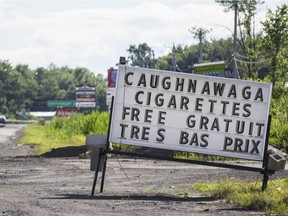 A sign advertising cigarettes and tobacco products on highway 132 just outside the Kahnawake Mohawk Territory in Montreal on Wednesday, July 9, 2014.
