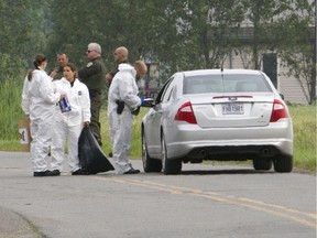Sûreté du Québec officers  at the scene of a deadly shooting in Marieville east of Montreal,  July 9, 2015.