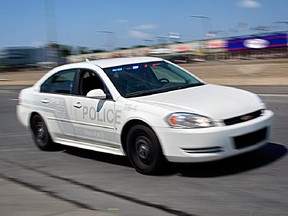 A white, unmarked Montreal police car.
