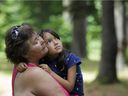 :Kanesatake resident Denise David and her adoptive daughter Jayda Lloyd, 7, stand in the place where Sûreté du Québec officers launched their assault on the Pines on July 11, 1990.