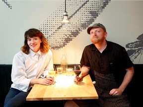 Restaurant Lili Co. co-owner Catherine Draws, left, and David Pellizzari, chef and owner, sit in the dining room of of the restaurant in Montreal on Friday June 26, 2015.