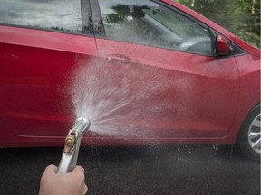 A car is washed in the driveway.