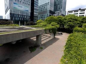 A group of people enjoy their lunch in Charles Daudelin's Viger Square public art installation, Agora, in Montreal on June 5, 2015.