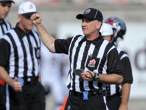 Referee Kim Murphy signals a penalty during Canadian Football League game between the Montreal Alouettes and Hamilton Tiger Cats in Montreal Sunday September 7, 2014.