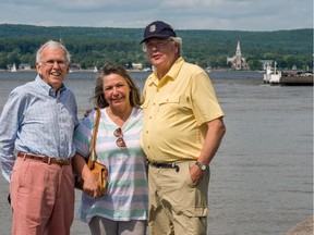 With the village of Oka behind them, Michael Legg, left, Lourena Montour, Chief of the Mohawk Council of Kanesetake, and John Angus, right, of Hudson, discuss plans to commemorate the forthcoming 25th anniversary of the Oka Crisis, at the ferry terminal in Hudson, on July 5, 2015.