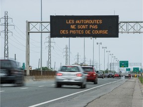 Cars travelling East on Highway 20, pass a Transport Quebec electronic sign near Sources Road in Dorval on June 7, 2015.