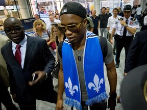 Didier Drogba is escorted through Pierre Trudeau Airport in Montreal, Quebec, on July 29, 2015. Drogba arrived from London England and was greeted by hundreds of chanting fans.