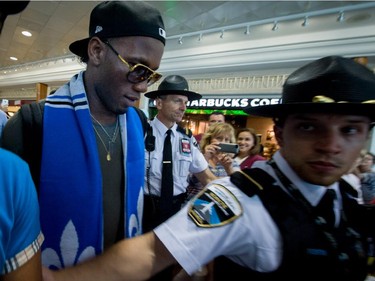 Didier Drogba is escorted through Pierre Trudeau Airport in Montreal, Quebec, on July 29, 2015.